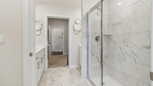 on suite bathroom with glass shower door