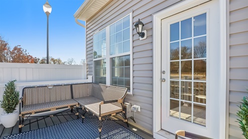 Rear exterior of the model home showing fenced patio