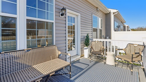 Rear exterior of the model home showing fenced patio