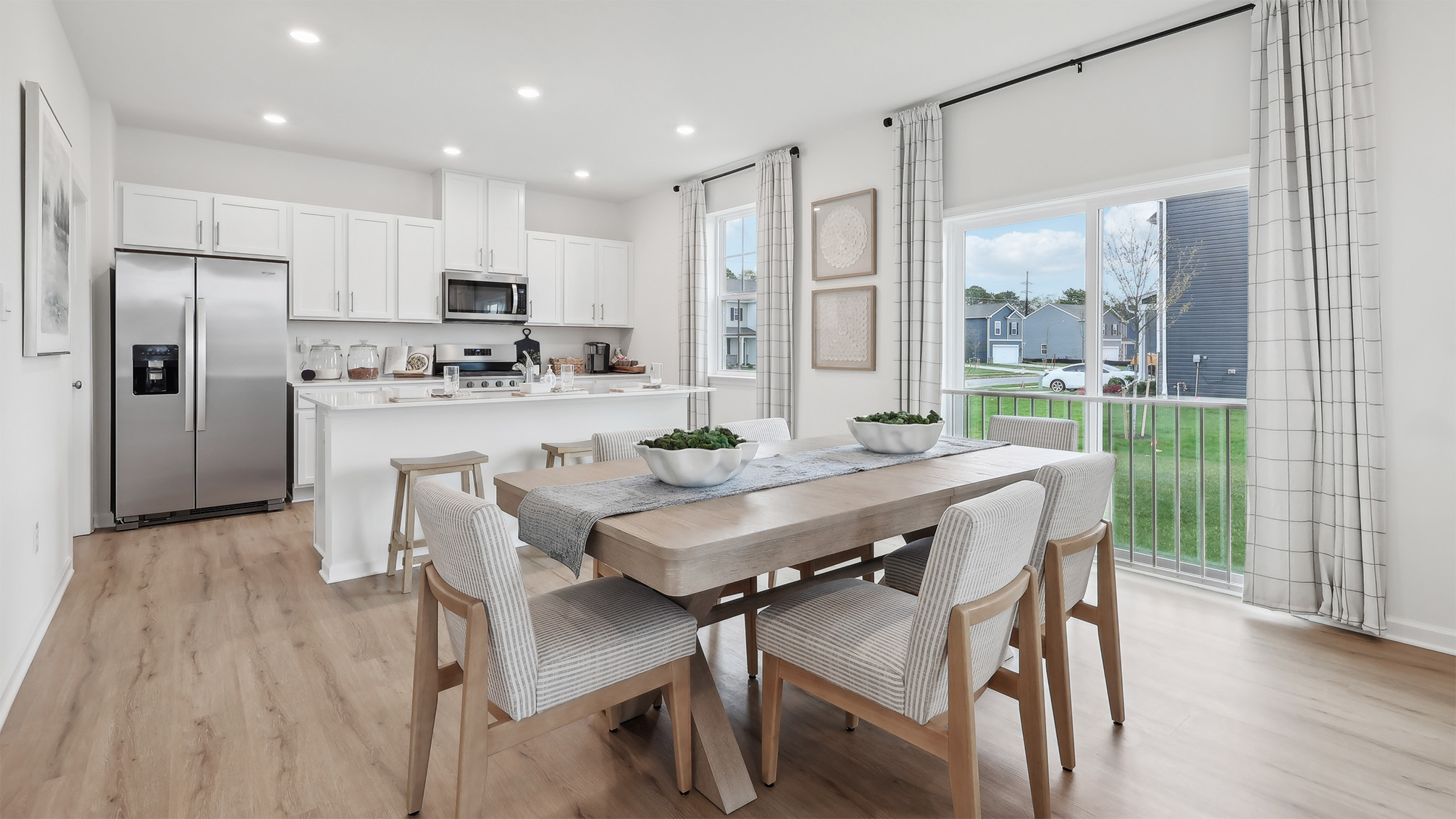 spacious kitchen with large island and dining table