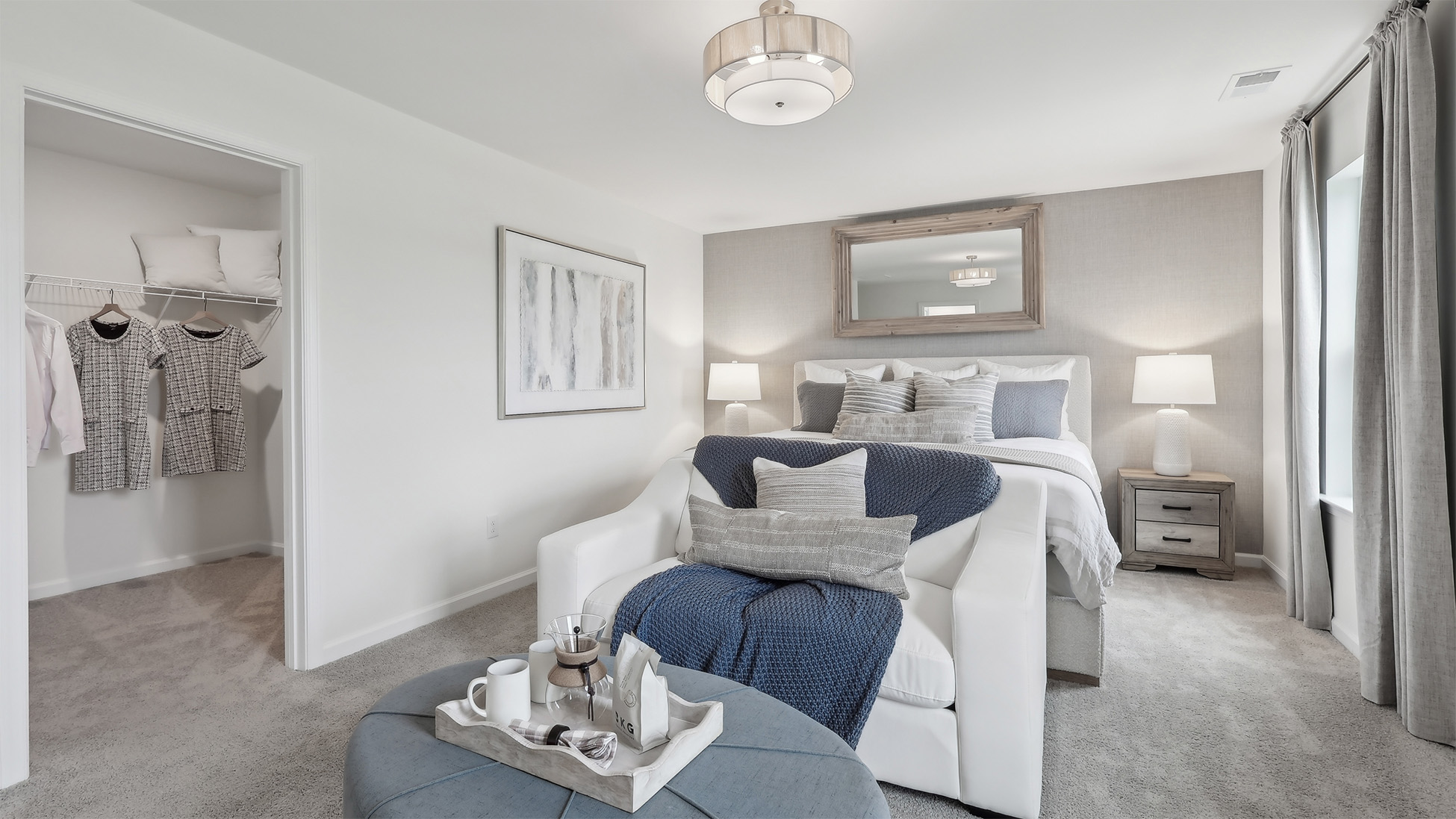 primary suite with large walk in closet, and full bath with double vanity
