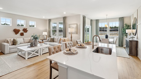 white kitchen with island and stainless-steel appliances