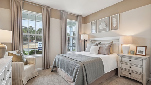 bedroom with beige carpet