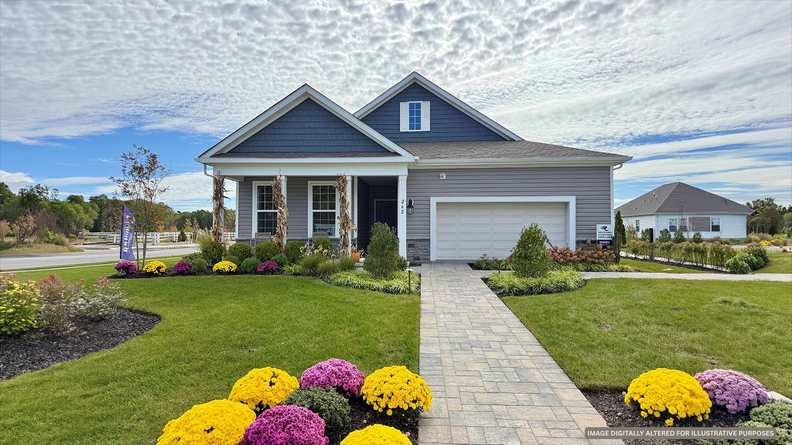 Model home exterior featuring fall landscaping