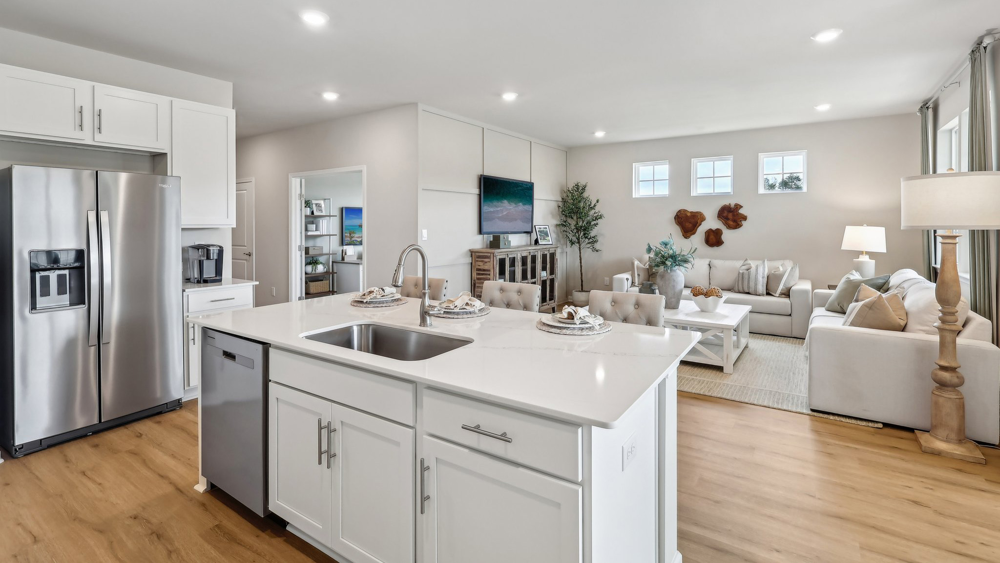 spacious kitchen with large island and open concept living room behind
