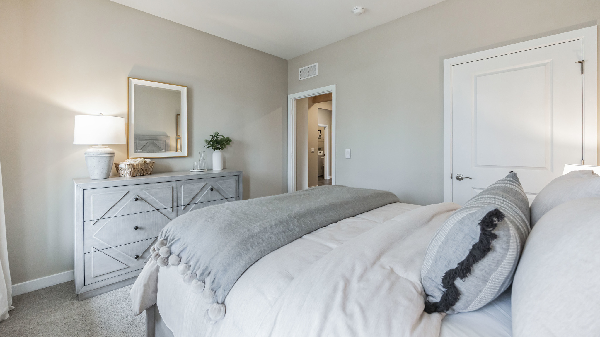 white bedroom with beige carpet