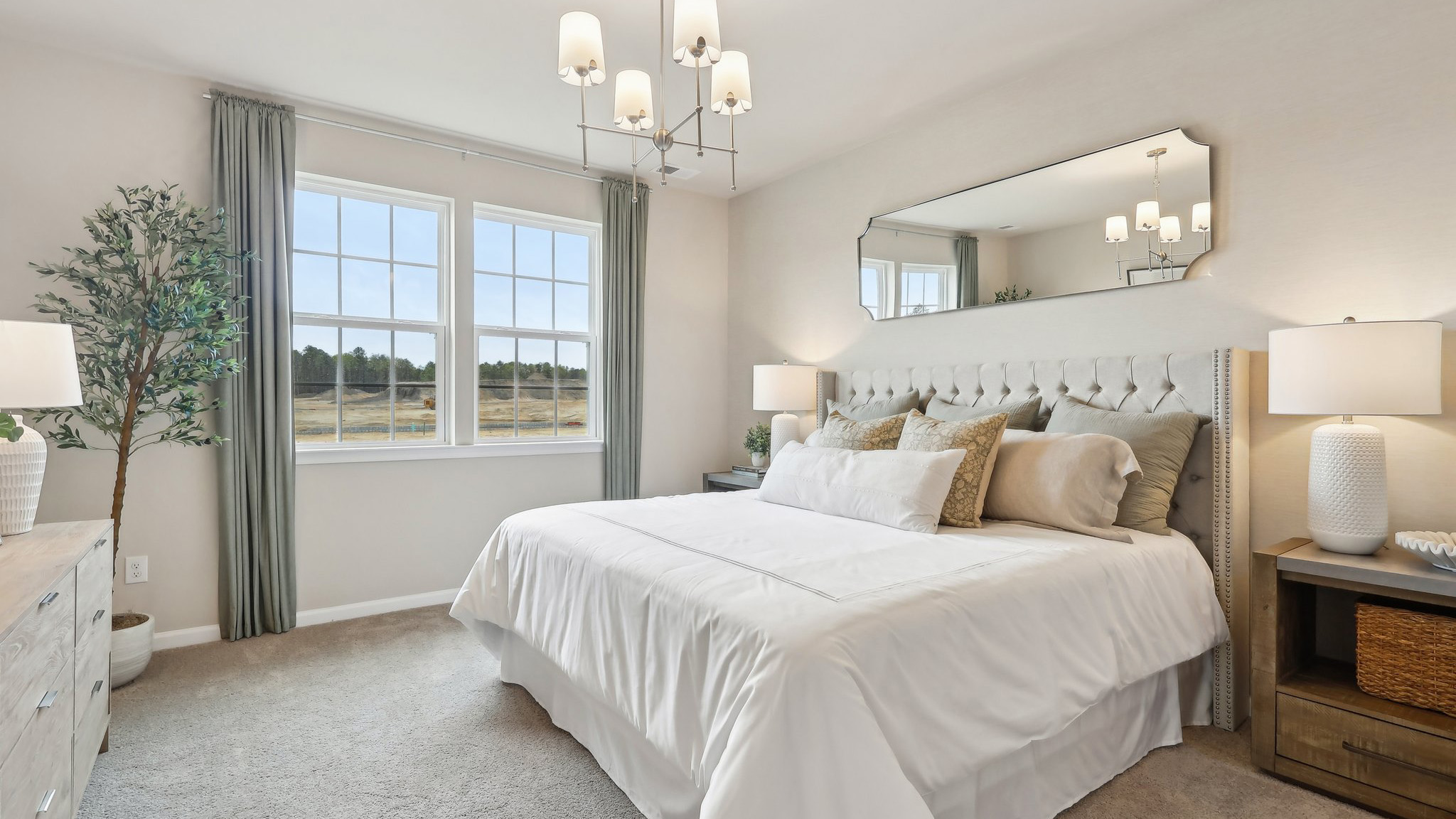 primary suite with large windows, walk in closet, and full bath