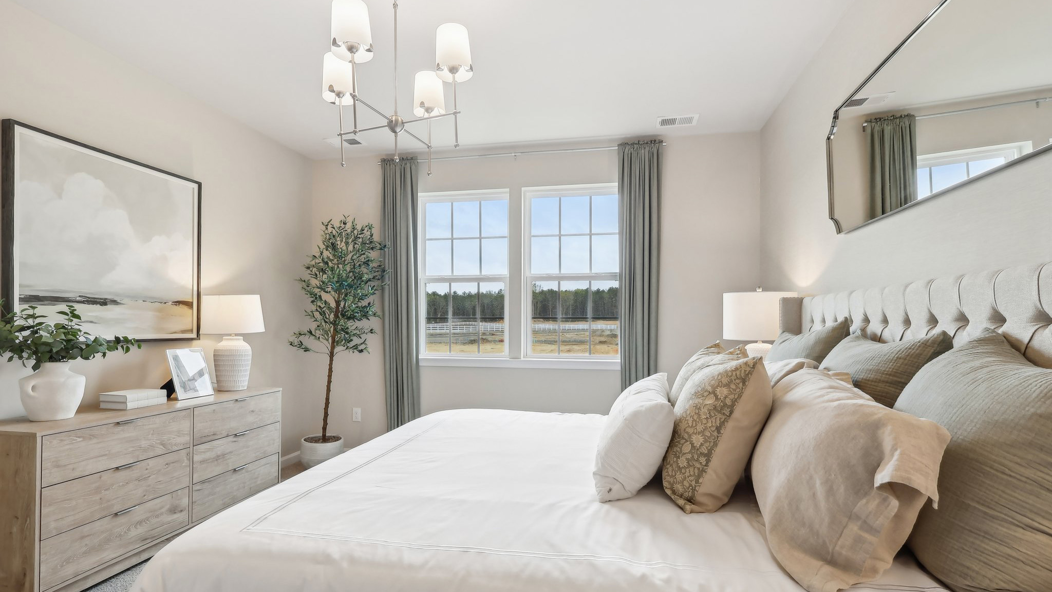 primary suite with large windows, walk in closet, and full bath