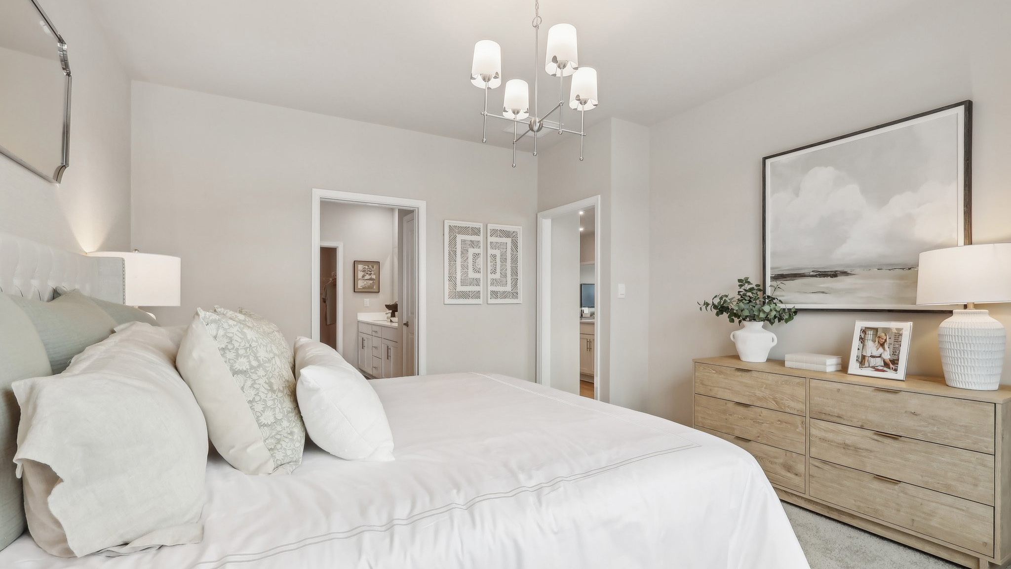 primary suite with large windows, walk in closet, and full bath
