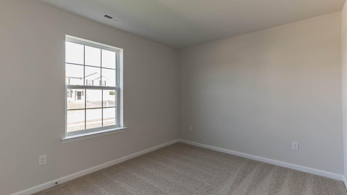 bedroom with beige carpet