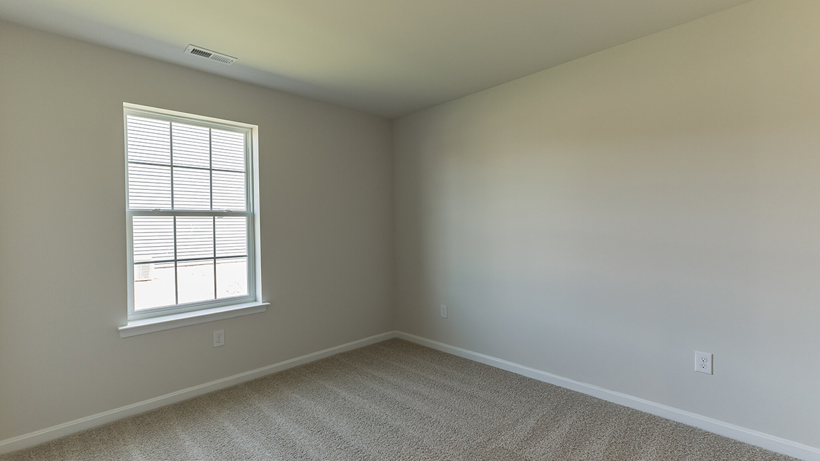 bedroom with beige carpet