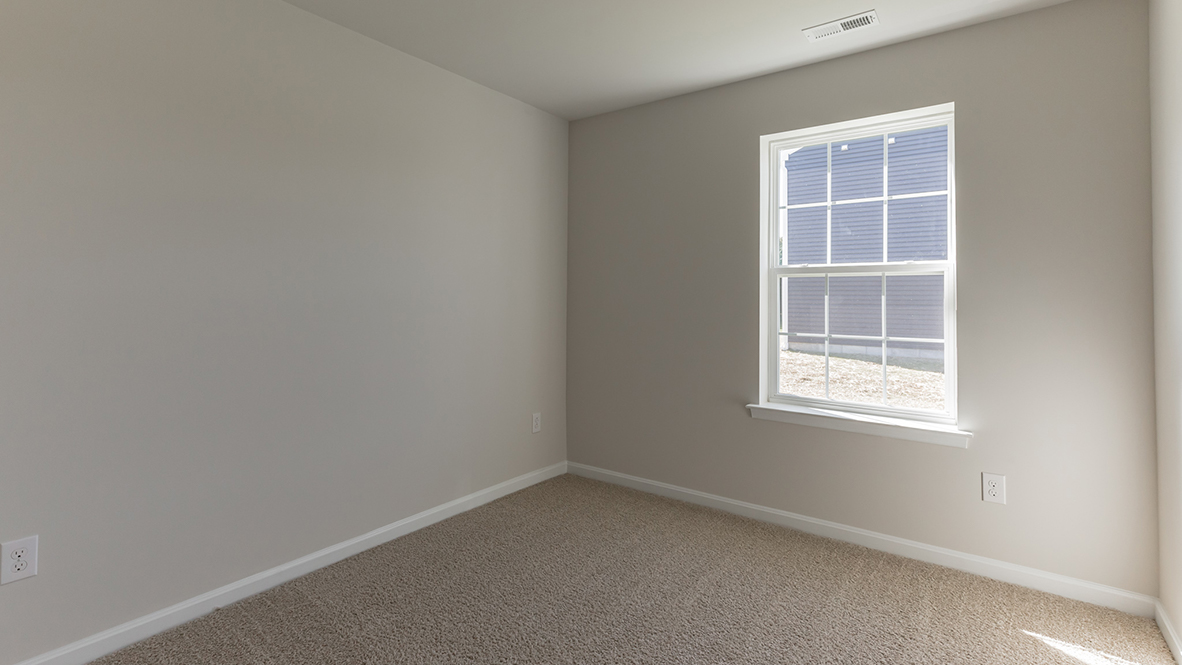 bedroom with beige carpet