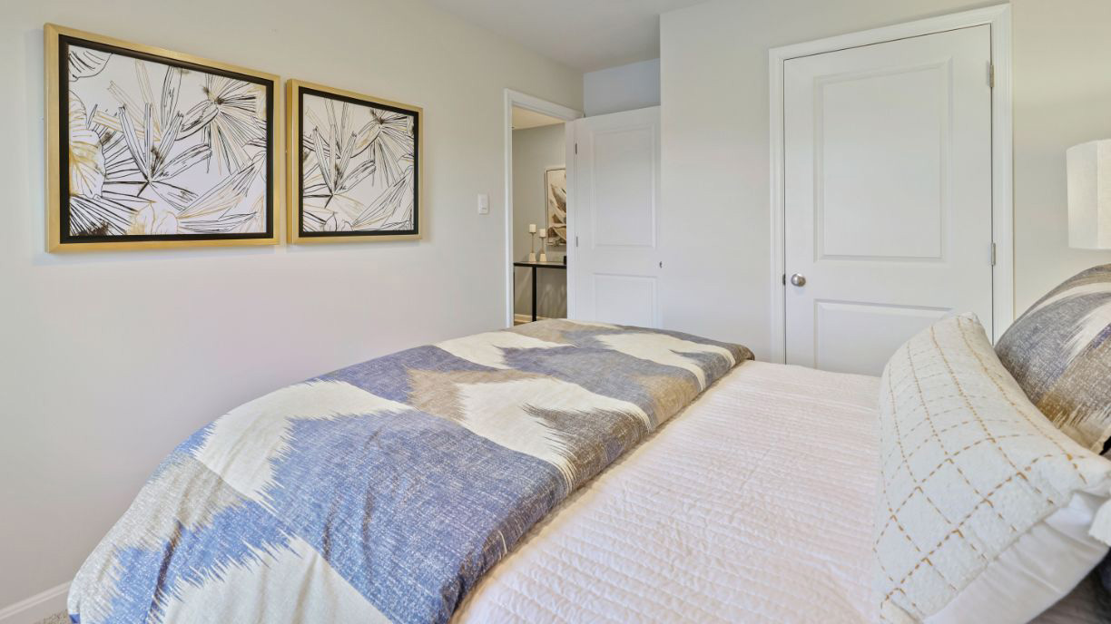 spacious bedroom with coastal design and large windows