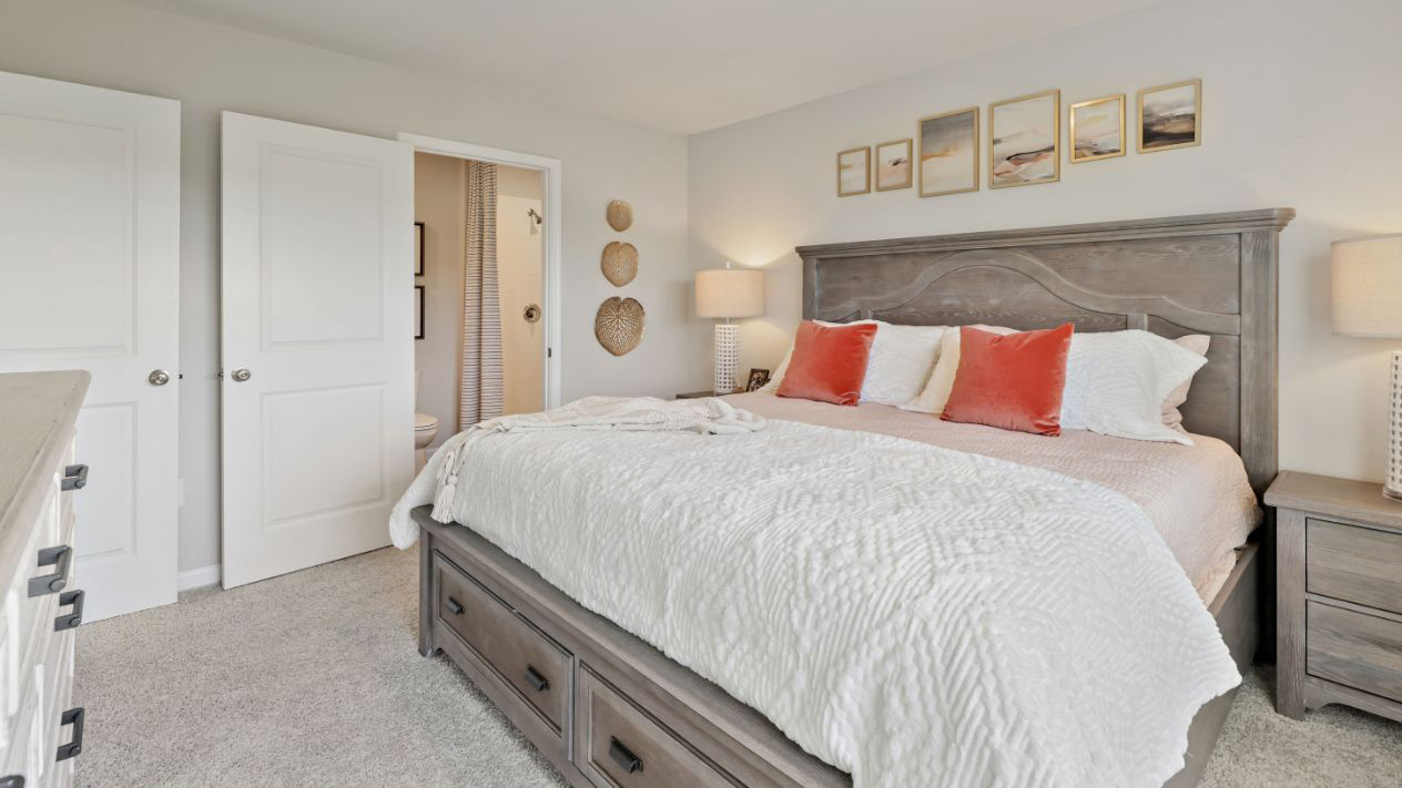 primary bedroom with pink tones and large windows