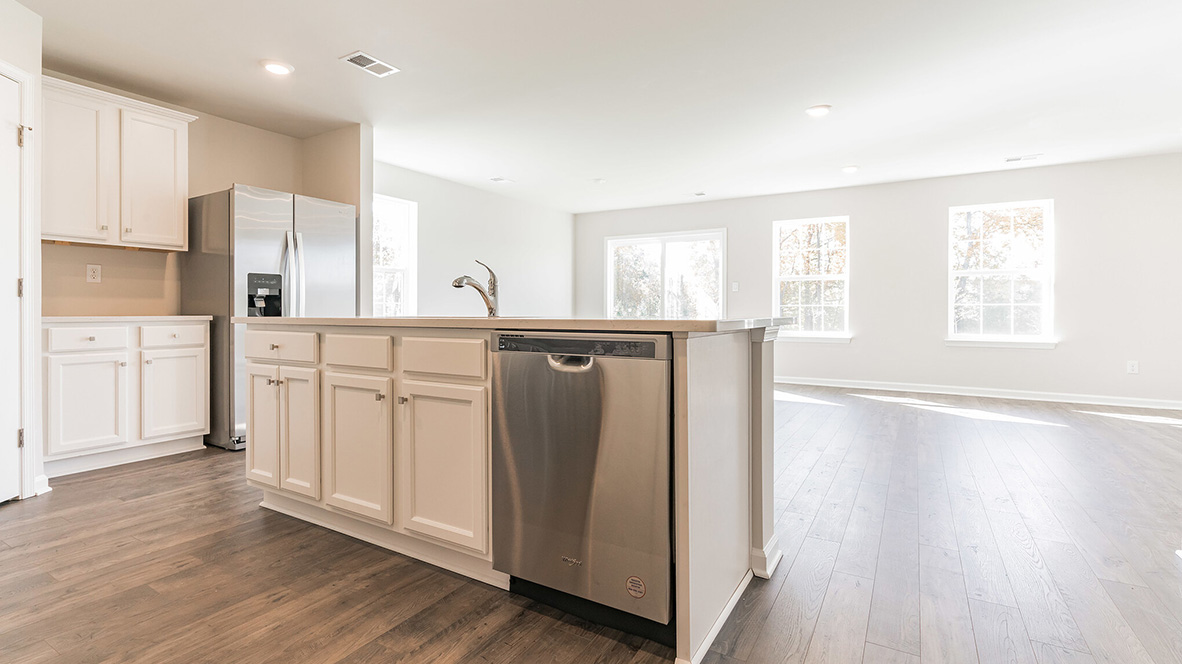open concept kitchen with island and stainless steel appliances