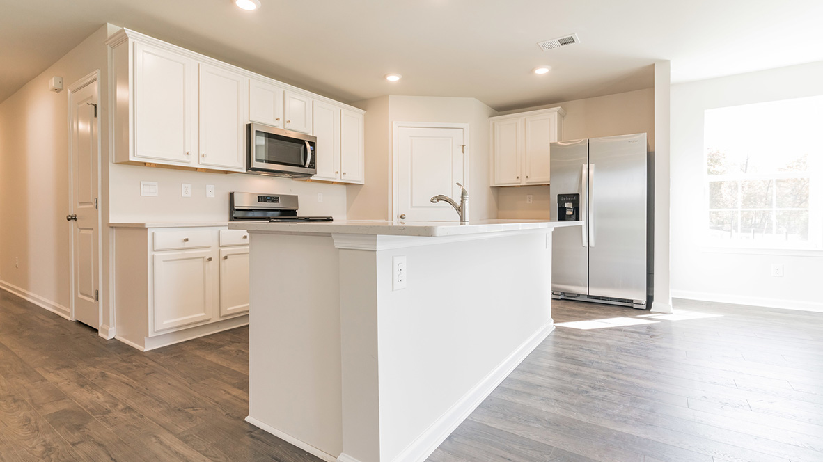 open concept kitchen with island and stainless steel appliances
