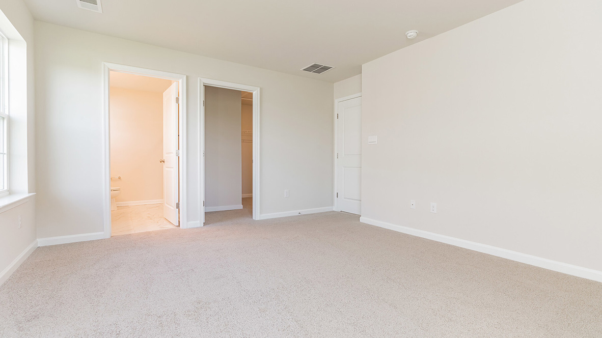 bedroom with beige carpet