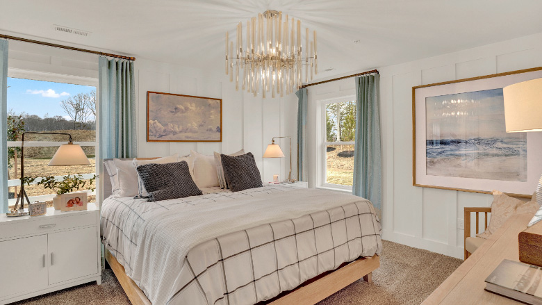spacious primary bedroom with light fixture