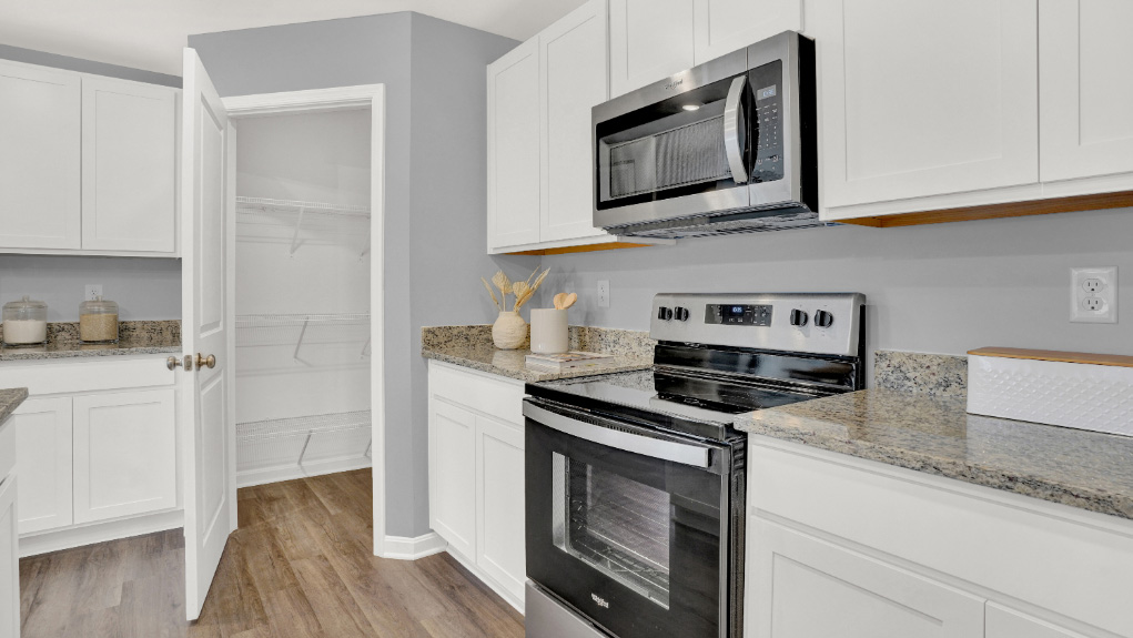 spacious kitchen with large island and modern design and spacious pantry