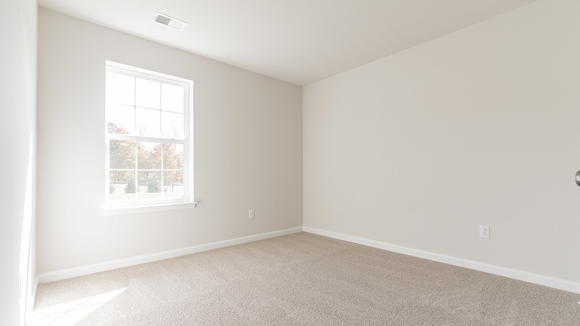 bedroom with beige carpet