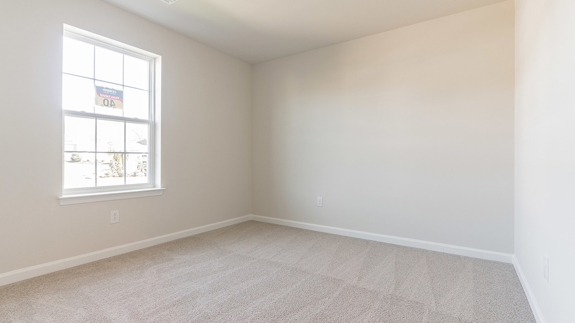 bedroom with beige carpet