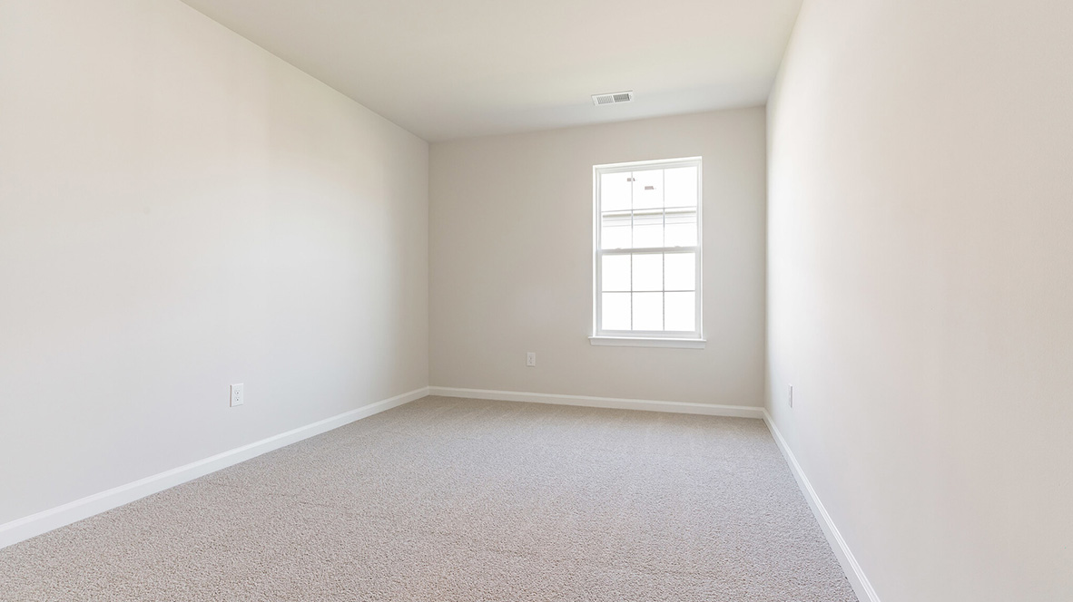 bedroom with beige carpet