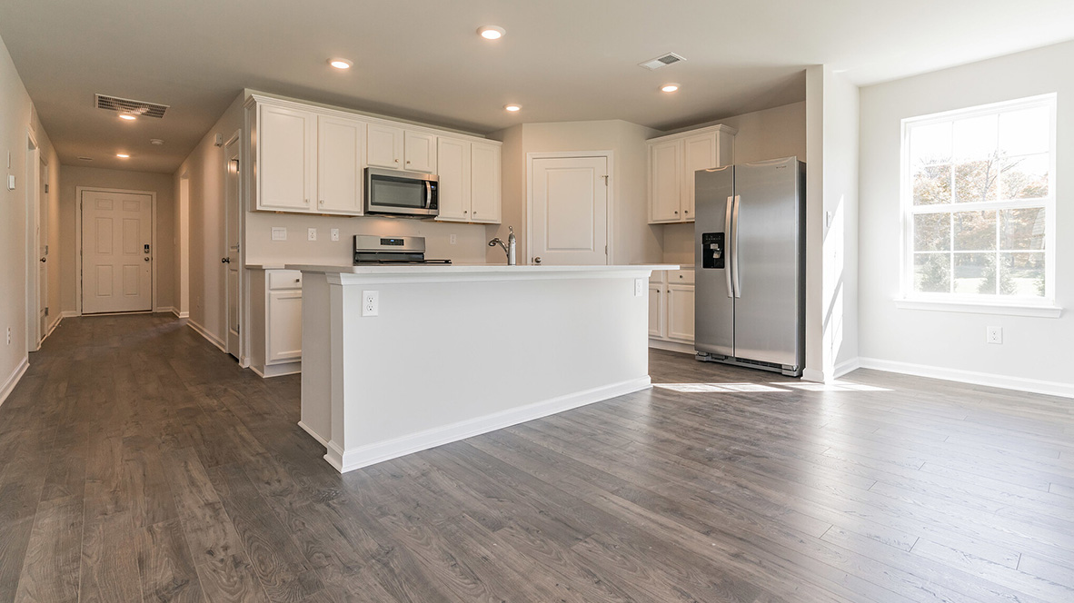 open concept kitchen with island and stainless steel appliances