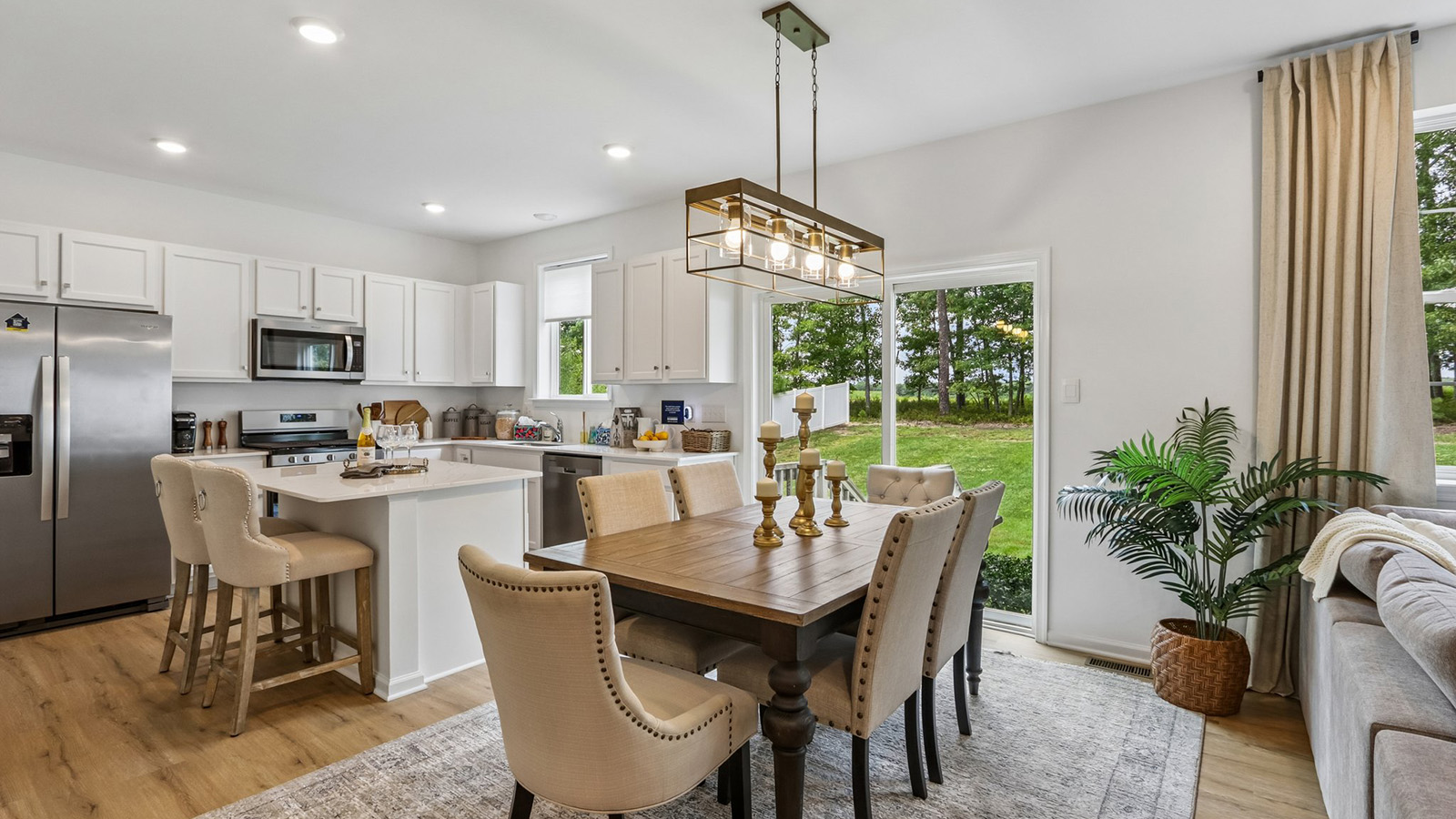 dining table and modern kitchen with quartz island