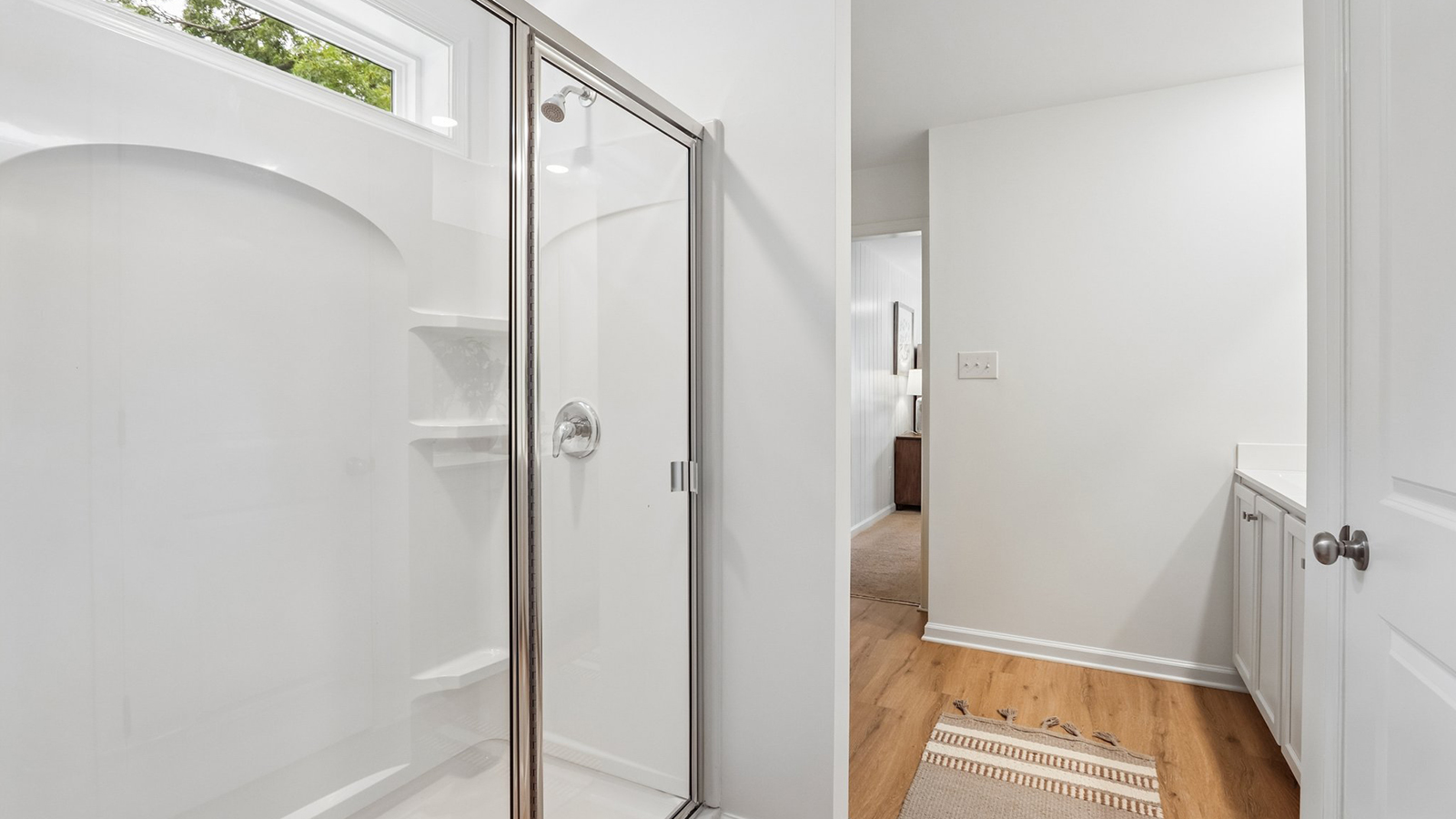 en suite bath with double vanity in the primary suite