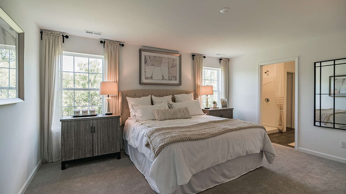 spacious primary suite with walk in closet and full bath