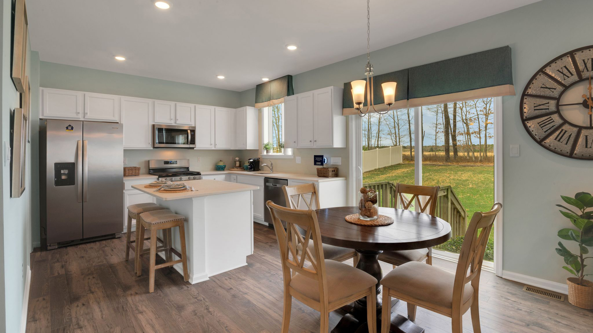 open concept first floor featuring a round table and spacious kitchen with large island