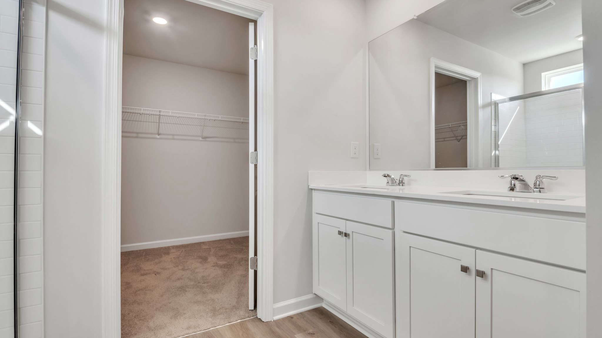 full bath with double vanity off the primary suite