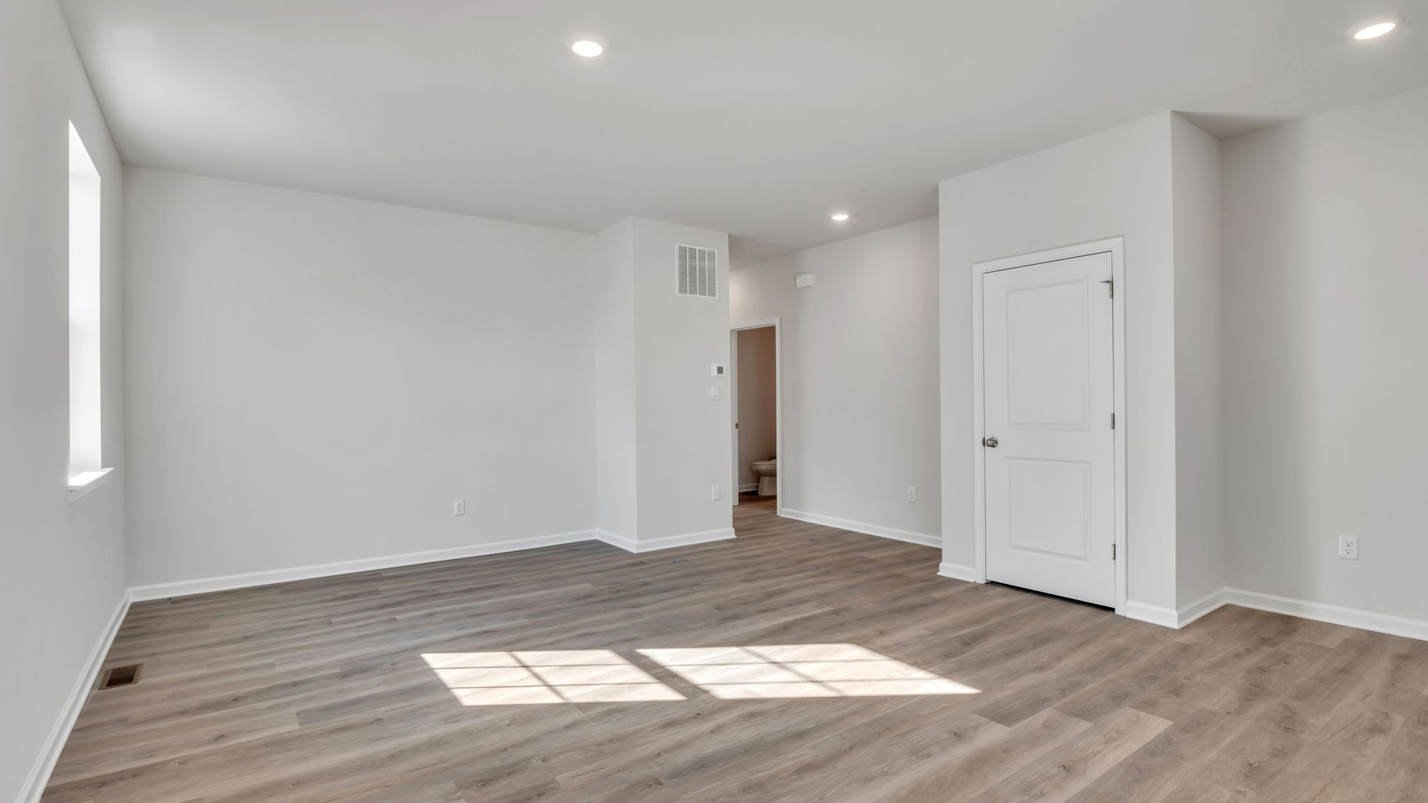 spacious first floor layout with hardwood throughout and a large quartz kitchen island in the center