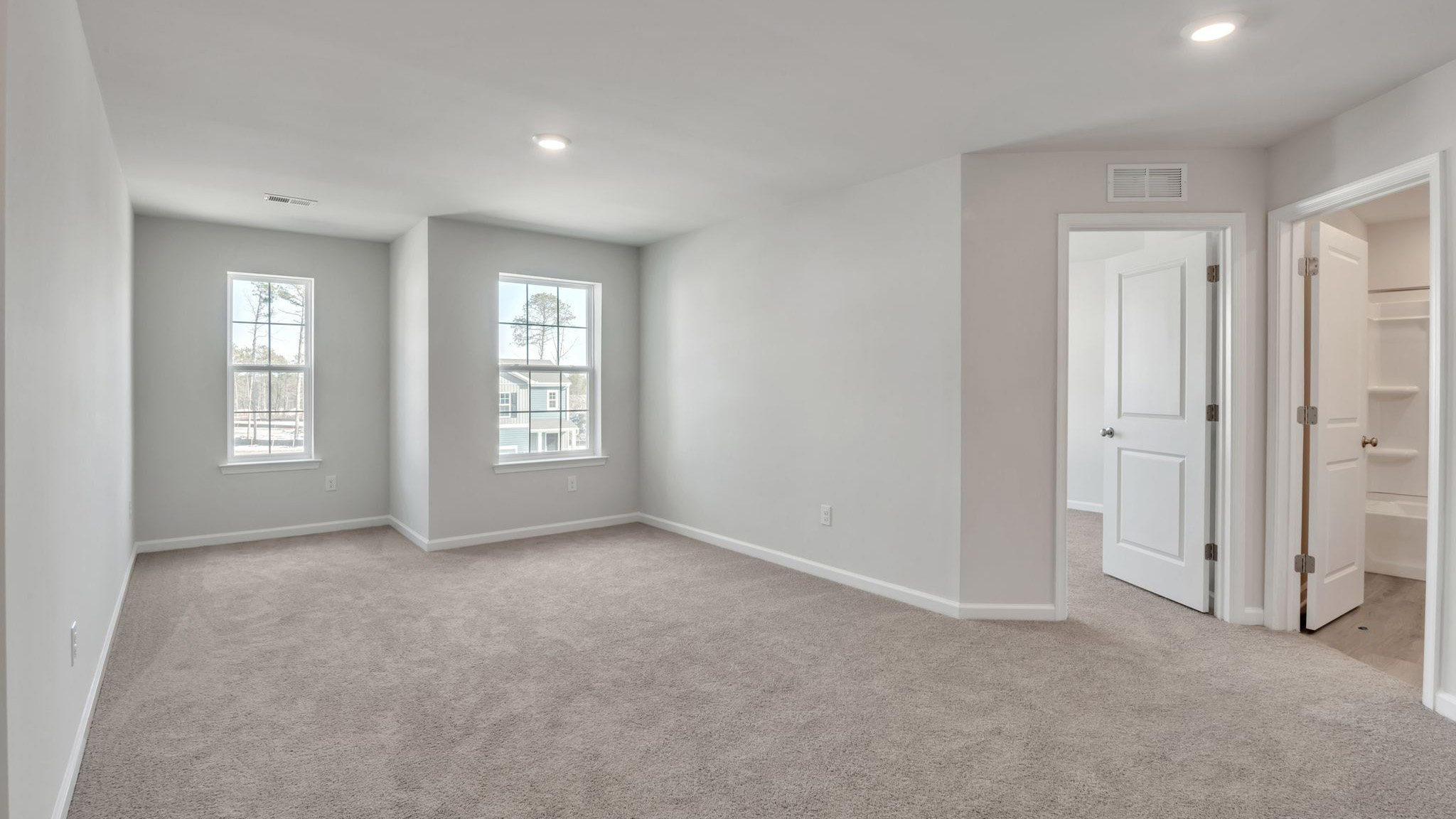 upstairs primary bedroom with spacious layout, large windows, large closet and double vanity
