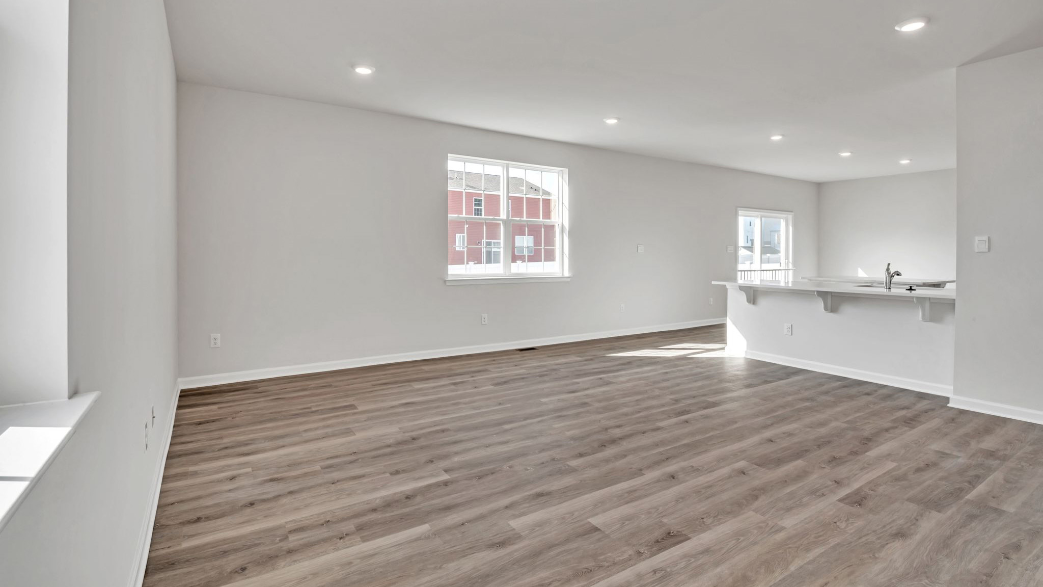 spacious first floor layout with hardwood throughout and a large quartz kitchen island in the center