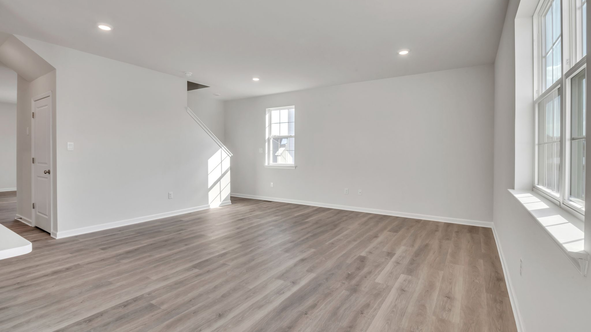 spacious first floor layout with hardwood throughout and a large quartz kitchen island in the center