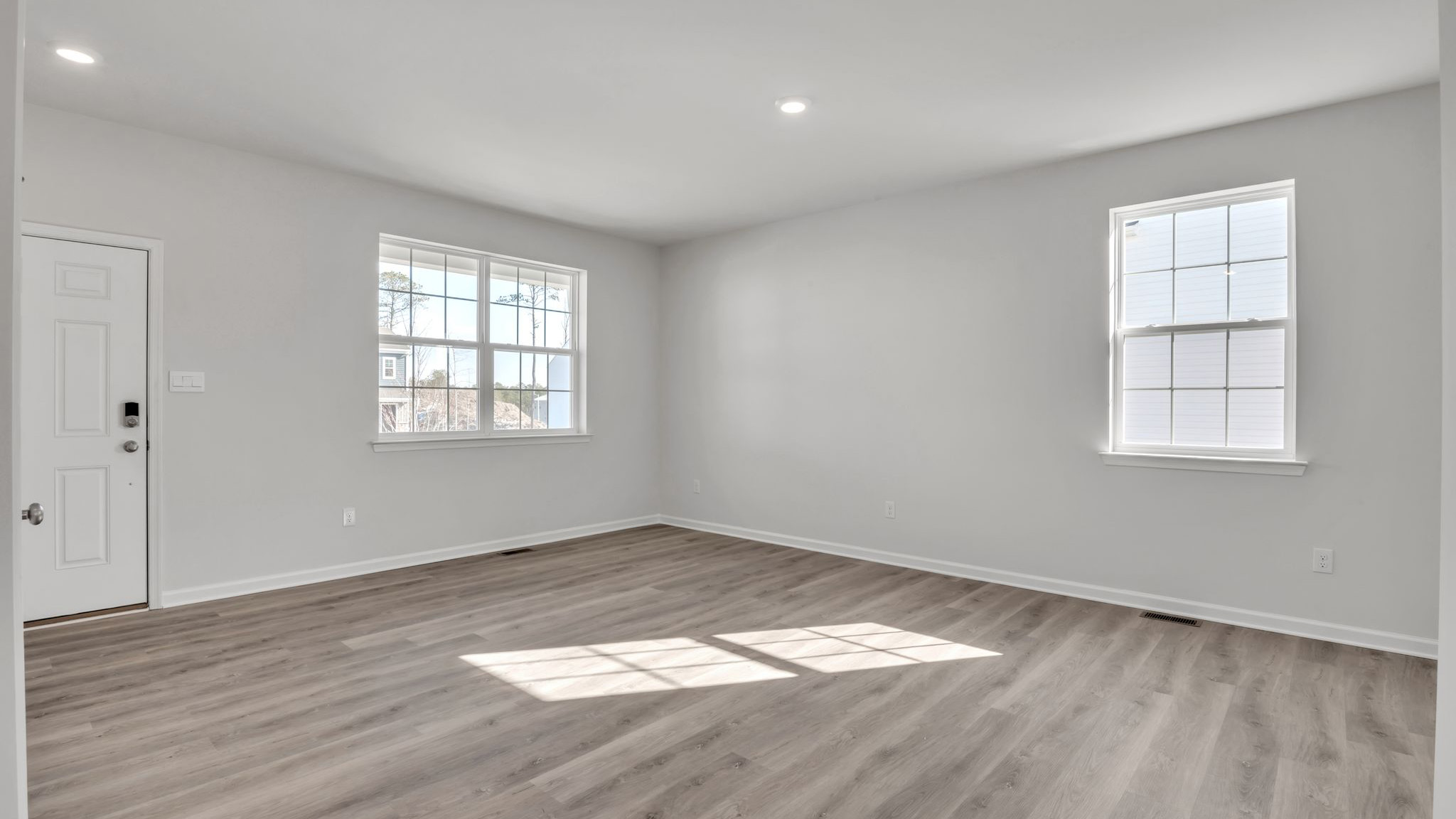spacious first floor layout with hardwood throughout and a large quartz kitchen island in the center