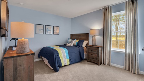bedroom with beige carpet