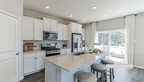 white kitchen with island and stainless steal appliances