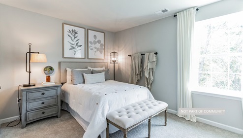 bedroom with beige carpet