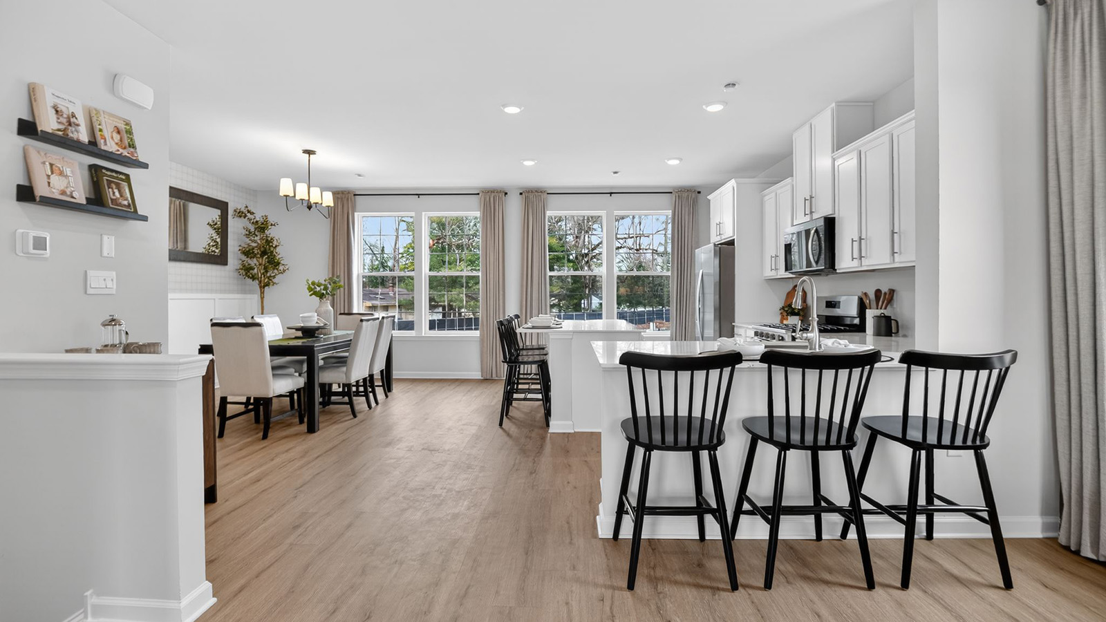 spacious kitchen with large island and dining table tucked behind