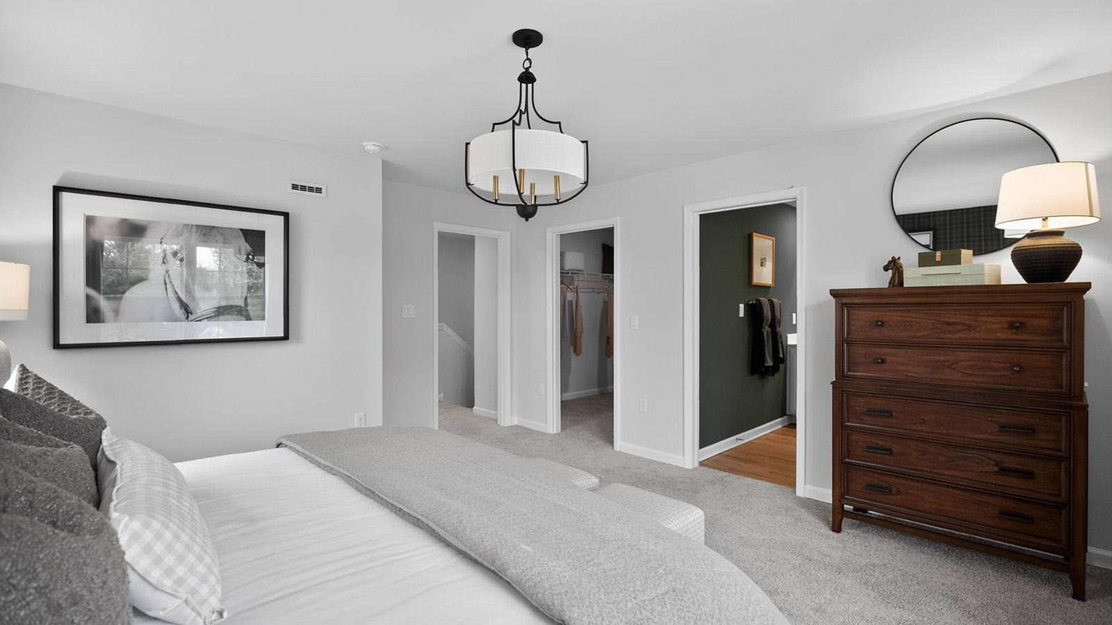 primary bedroom with mid century modern design and beautiful light fixture