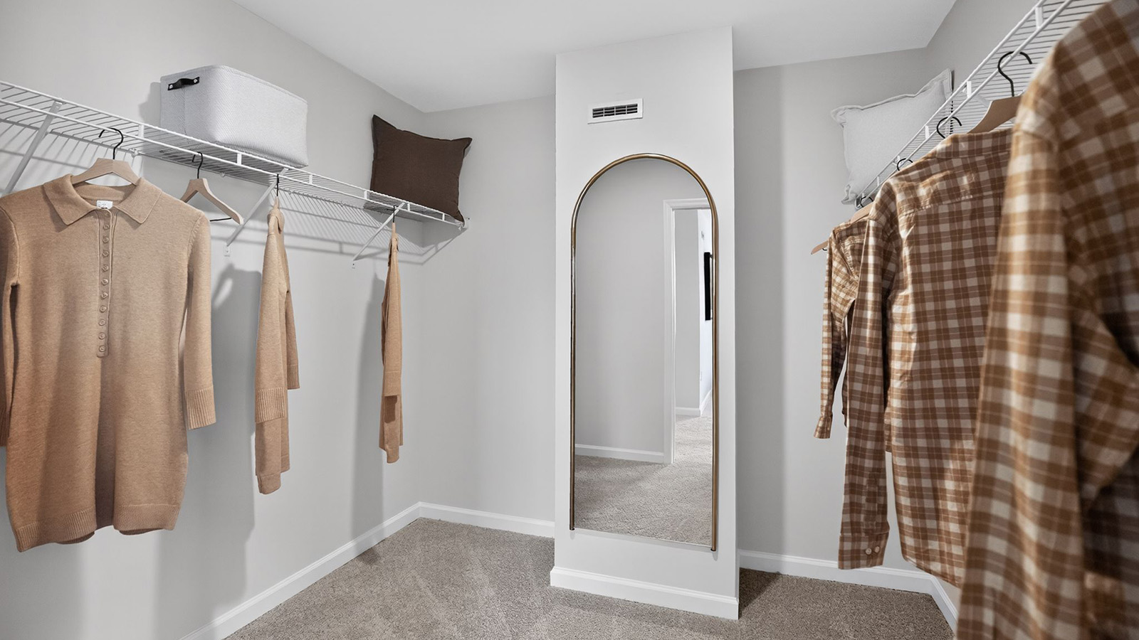 spacious walk in closet with mirror off the primary bedroom
