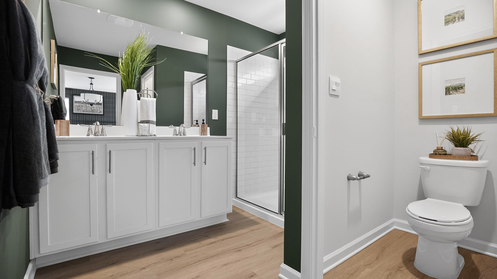 Elmore Model primary bathroom with green access walls and white accents