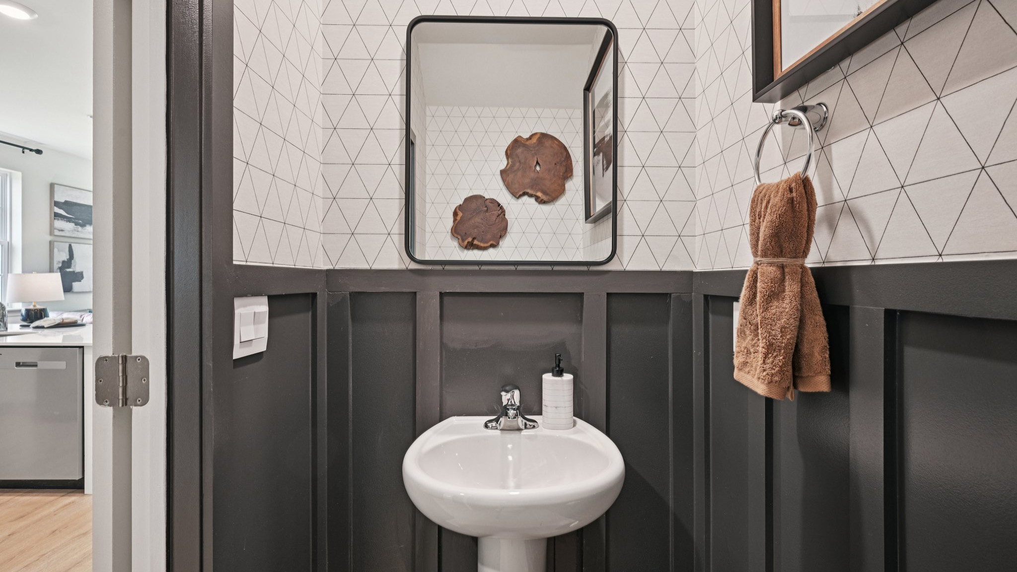 modern powder room with dark accents colors on the first floor
