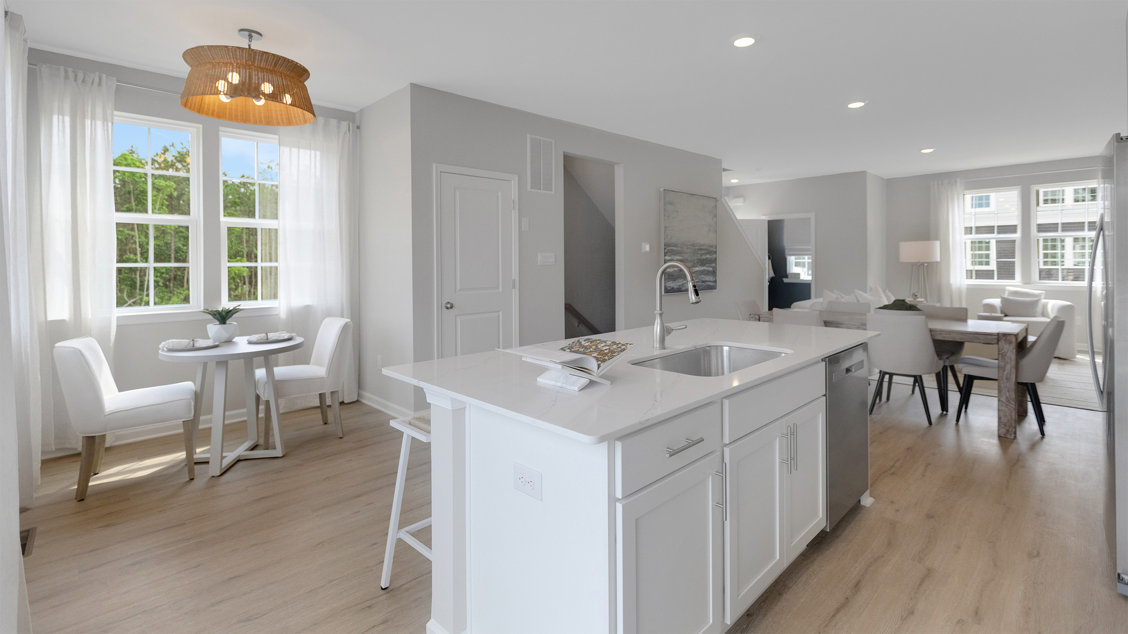 spacious kitchen with large island and eatery off to the side by a window
