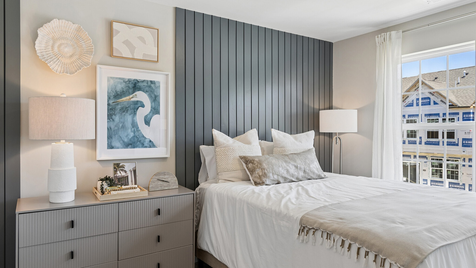 spacious bedroom with modern design and large windows and closet space