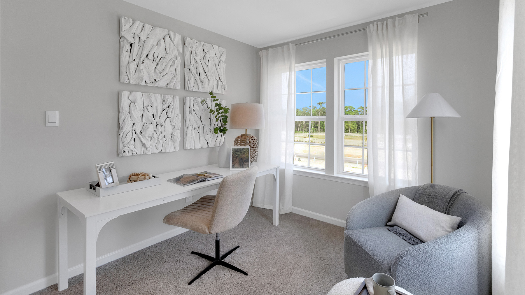 second bedroom with gray accent wall and large windows