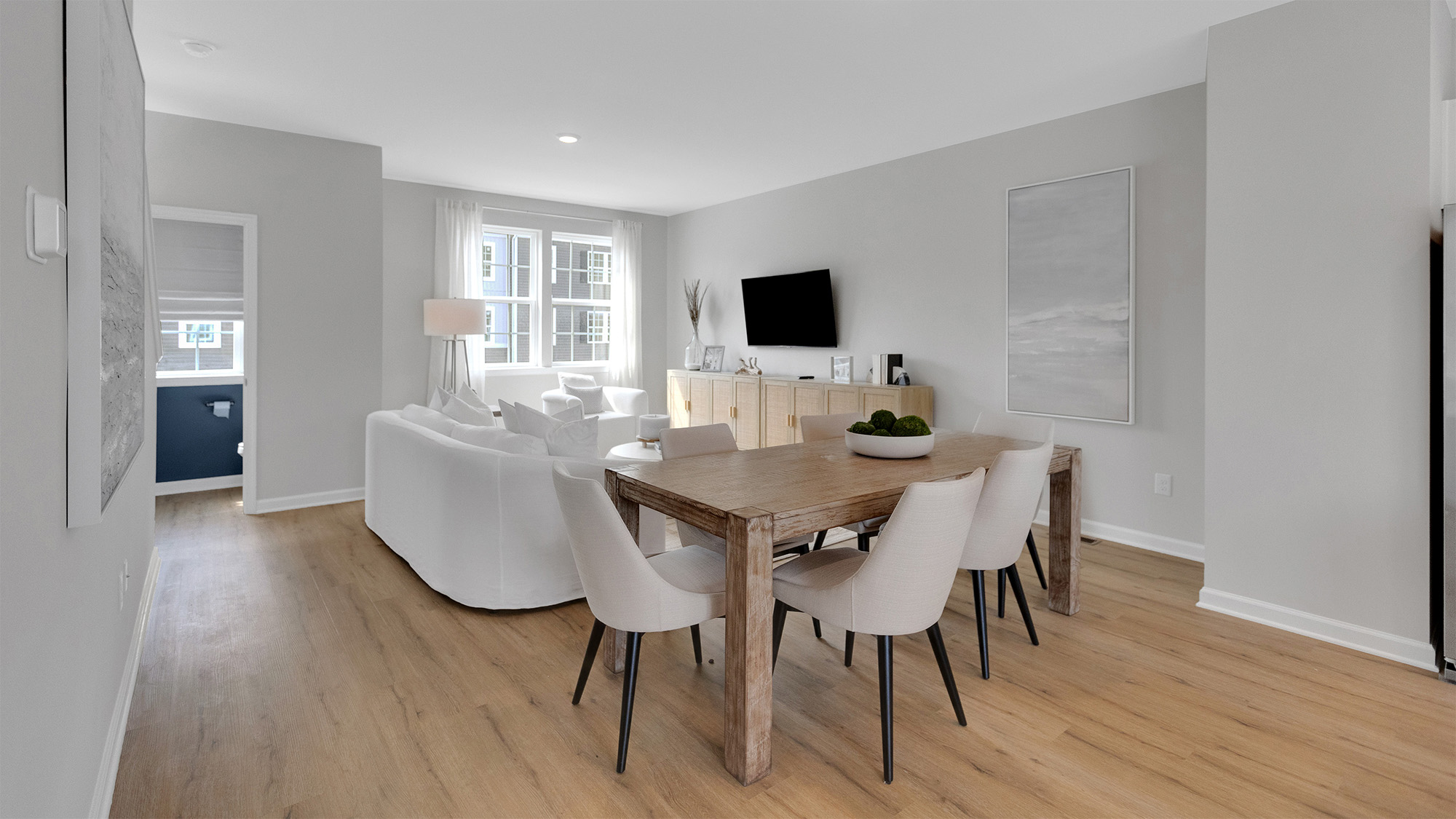 modern dining room table with living room behind