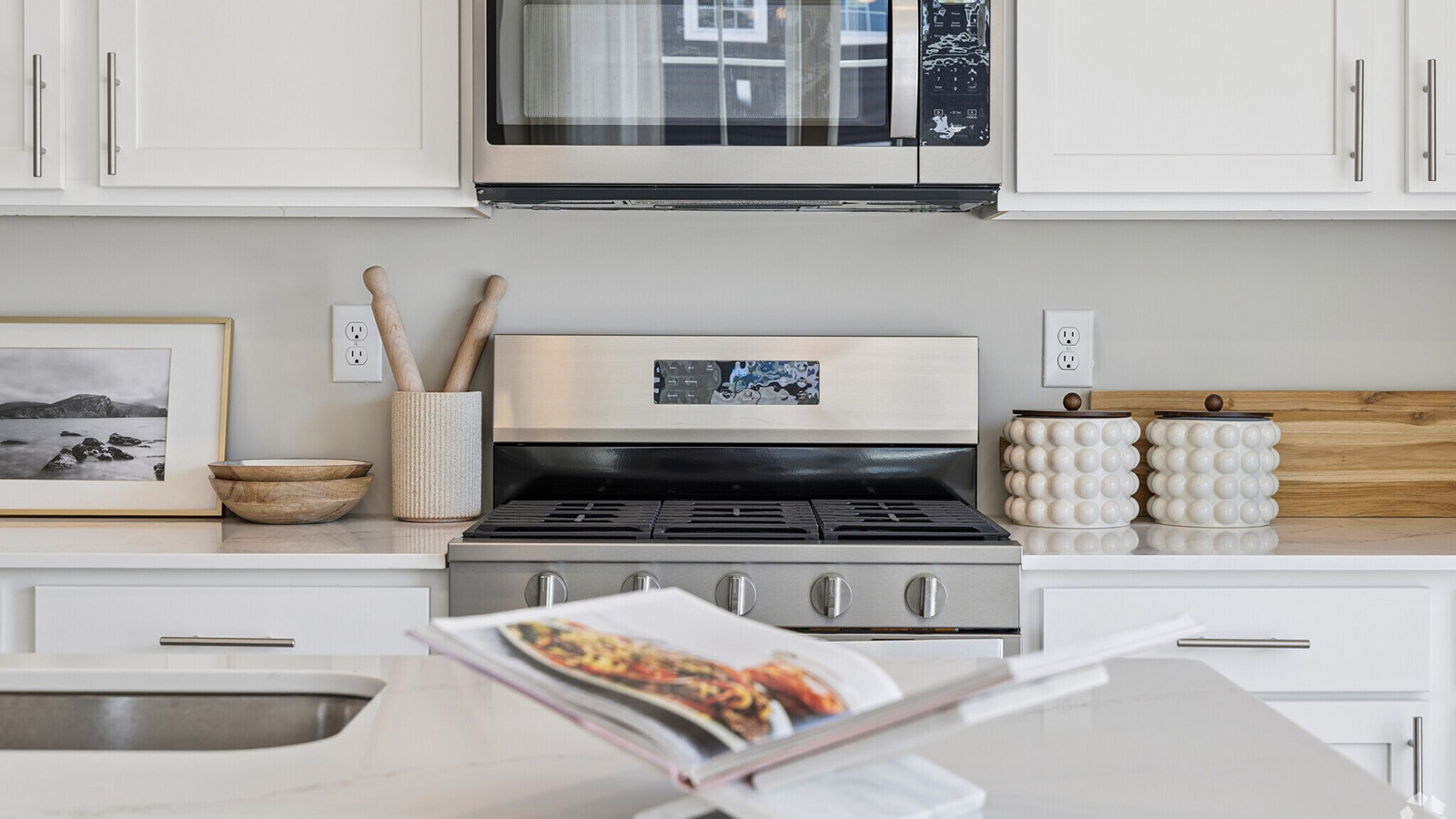 kitchen with quartz island and white cabinetry